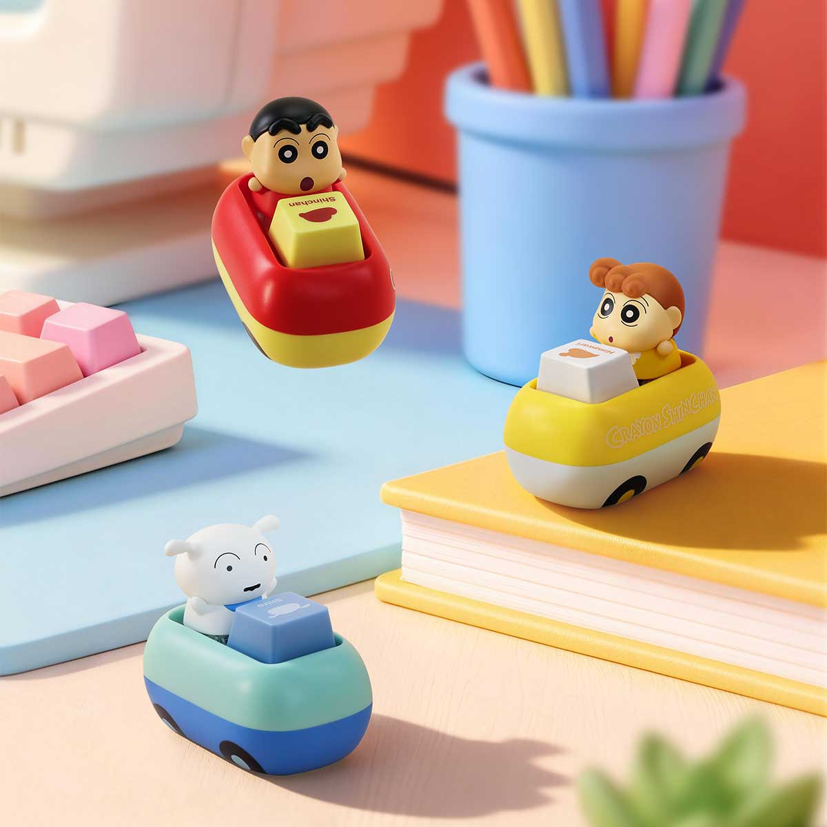 Shinchan, Himawari and Shiro keycap car figures beside a pink keyboard, Crayon Shinchan Tap & Relieve Series