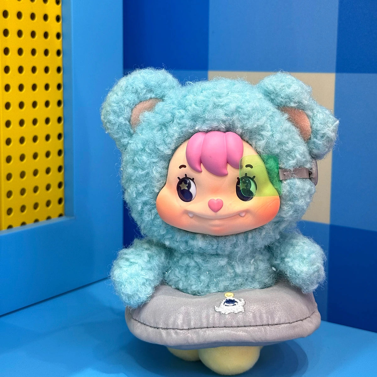 Little Buns blue bear plush character seated in a silver flying-saucer costume