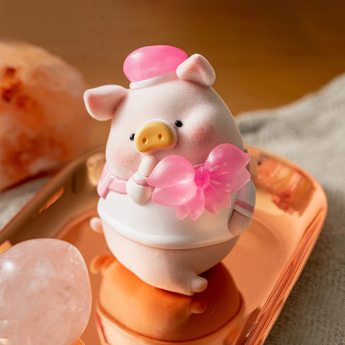 JOY piggy in white sailor uniform and pink beret holding a pink cherry-blossom bow, Lulu in Bloom Sakura 2
