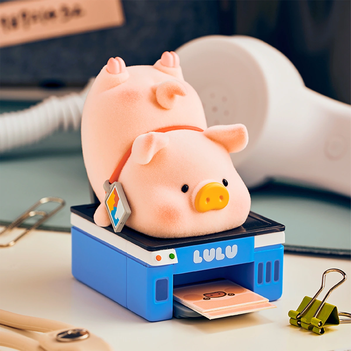 Lu Can't Do It piggy collapsed on a blue LULU printer scanner, LuLu Piggy Office