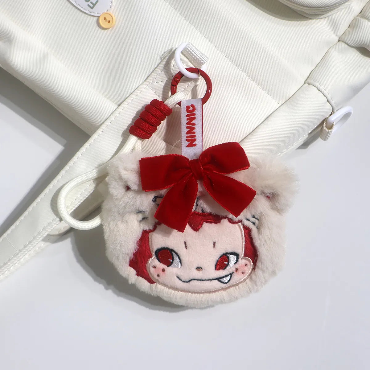 NINNIC Party Kitty scented charm clipped to a cream tote bag, Wild & Free aroma charm