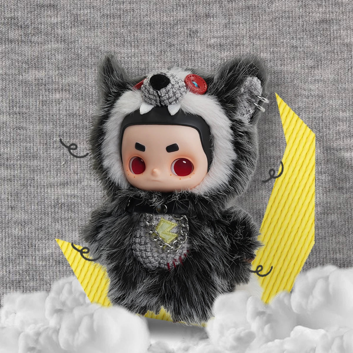 NOOK plush in a black cat costume with red button eyes on a moon-and-cloud set