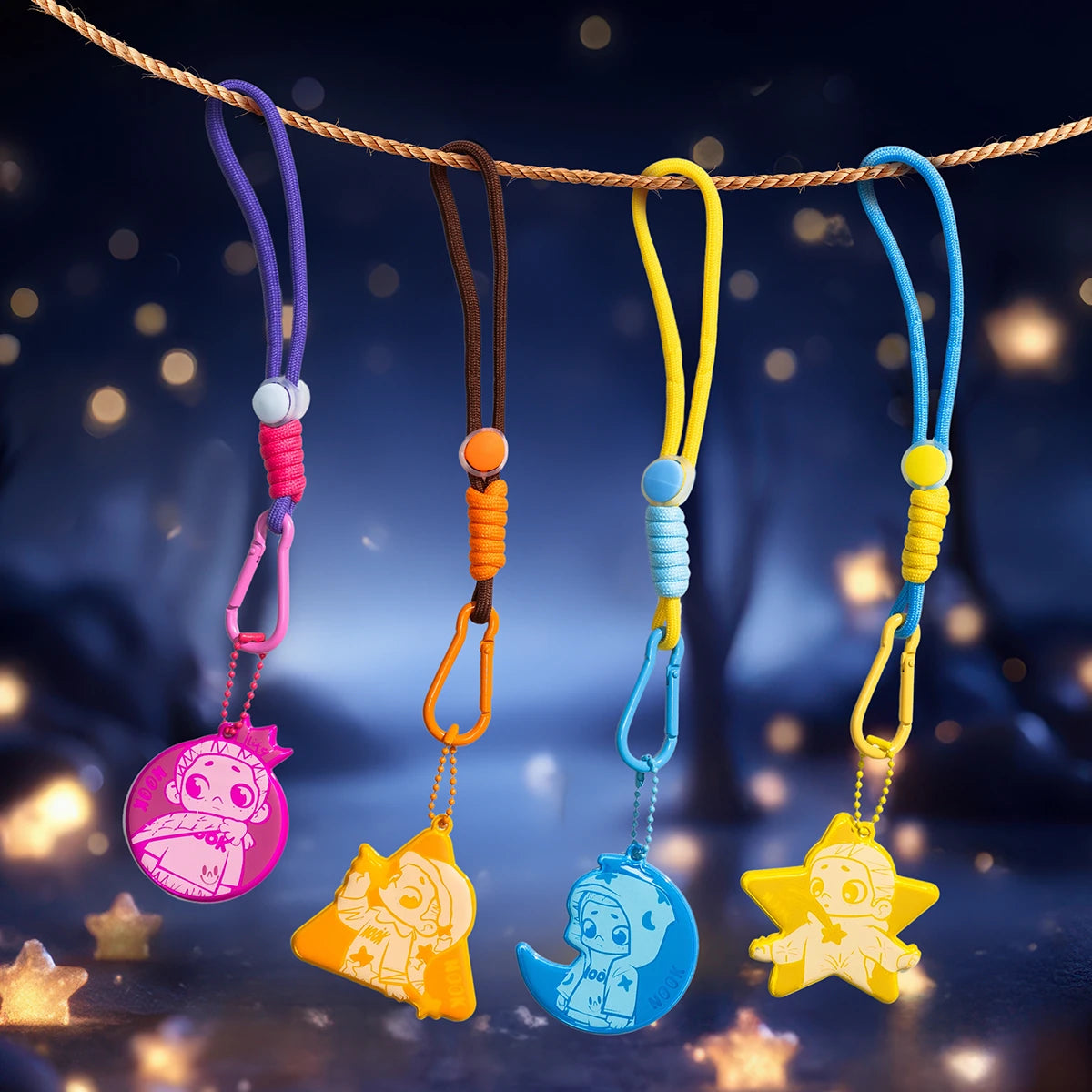 Four reflective NOOK character pendants in pink, orange, blue and yellow hung on a rope, NOOK Night Series