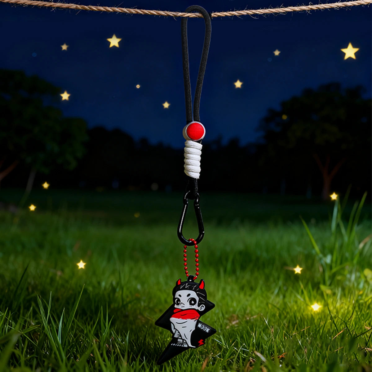 Secret Black star reflective pendant hanging on a black strap in a starry field, NOOK Night Series