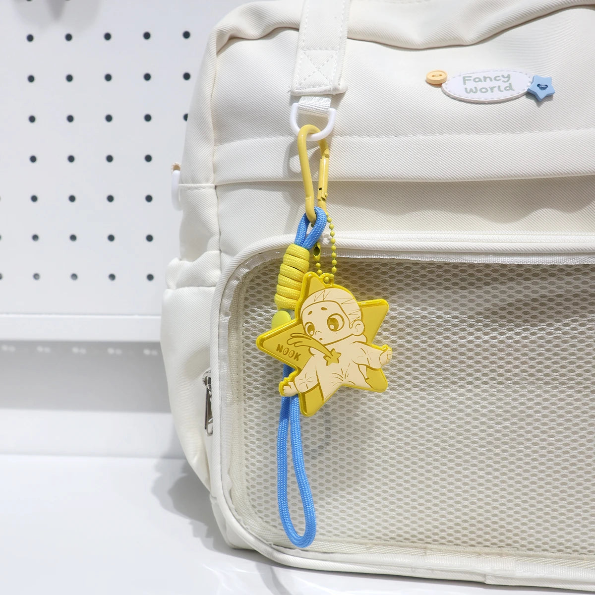 Yellow Star reflective NOOK pendant clipped to a white backpack, NOOK Night Series