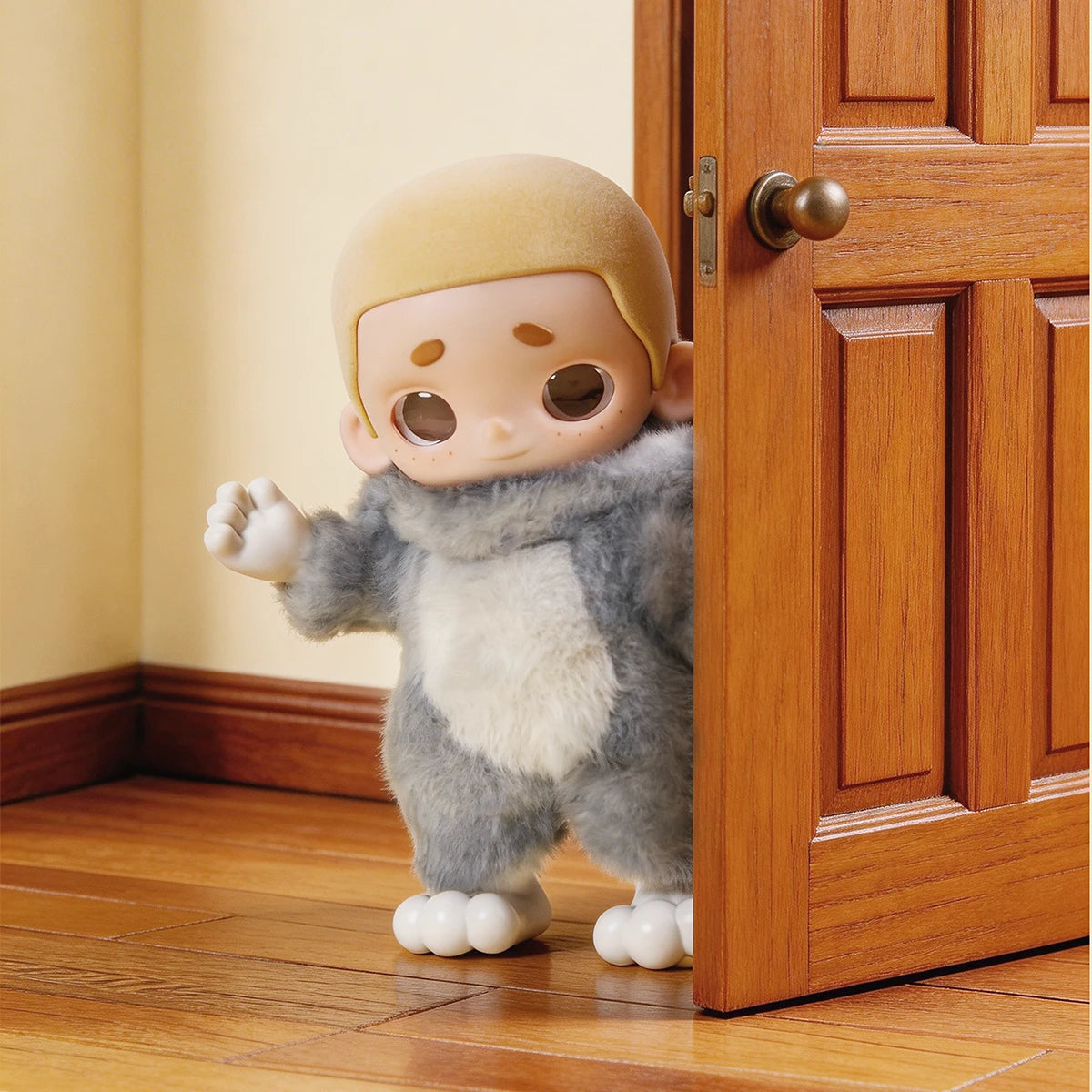 Back view of the Nook doll in its Tom cat costume peeking around a wooden door, Nook x Tom and Jerry