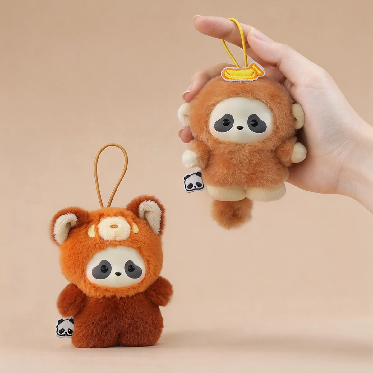 Red Panda Cub and Banana Monkey panda plush keychains held in hand, Panda Roll The Zoo In Hands