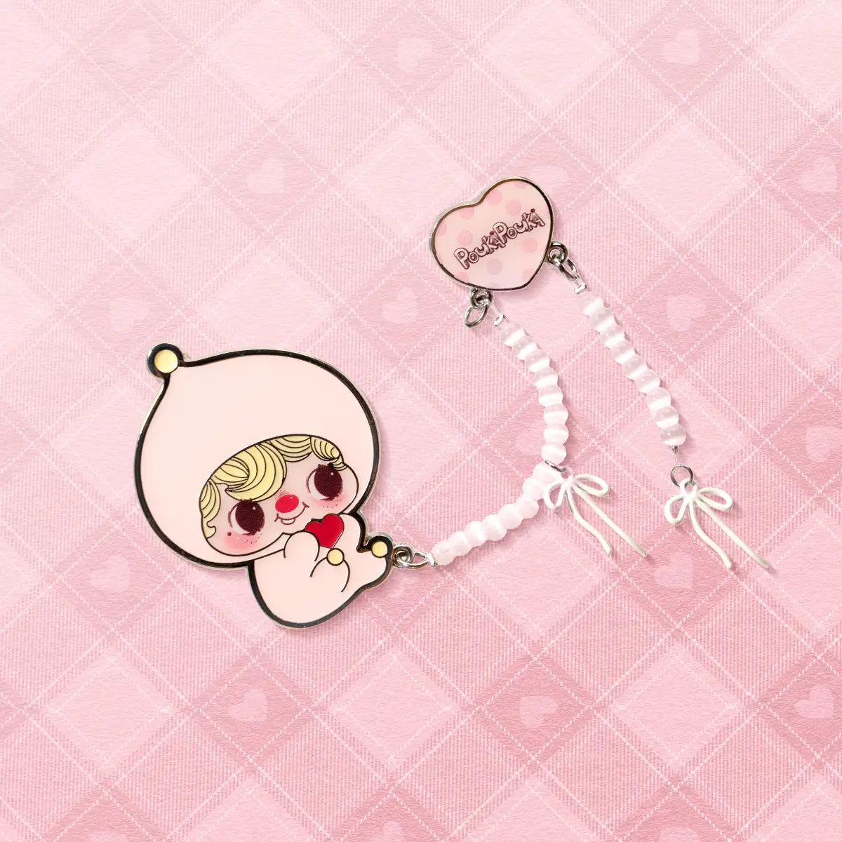 POUKA Blush Pink Brooch on pink heart backdrop, pink enamel baby with white beaded bow strap, POUKAPOUKA