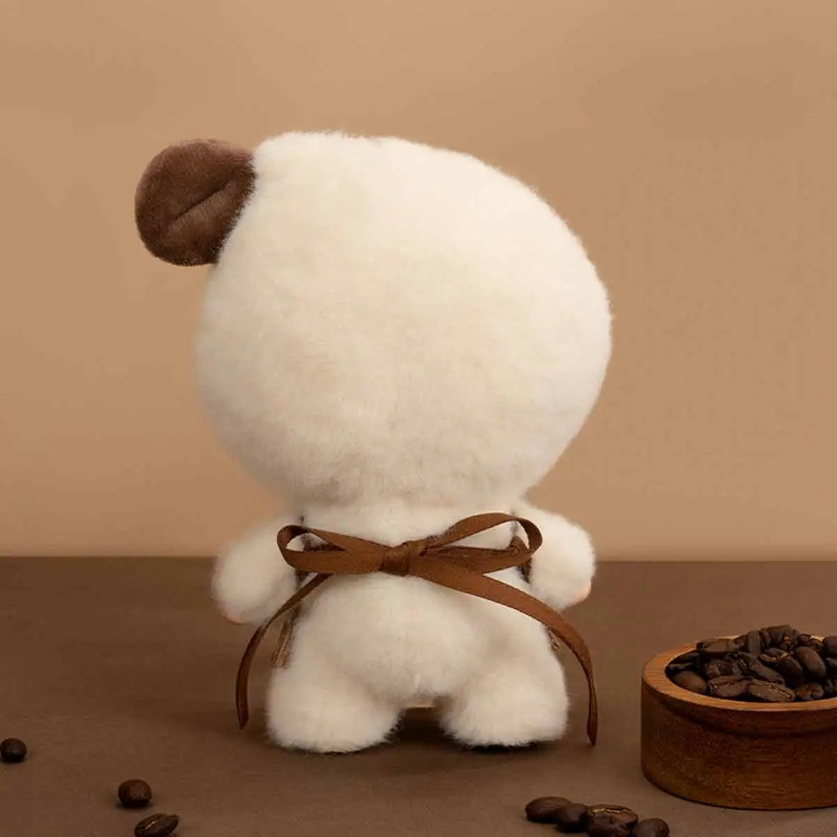 Back view of Pouka Pouka Coffee Time doll showing the brown ribbon bow tying its tan apron