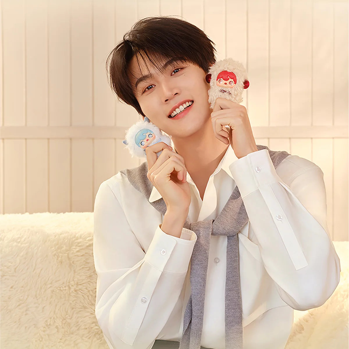 Ambassador Zhou Keyu smiling with two POUKAPOUKA Pocket Cosmos pixie plushes, by 52TOYS
