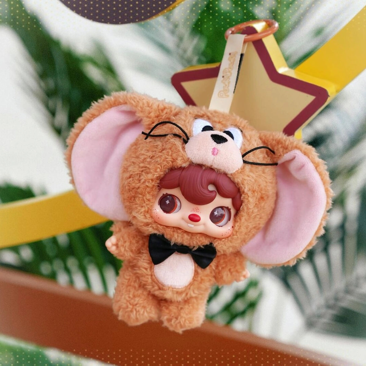 POUKAPOUKA brown Jerry costume hanging from a star-shaped bag charm