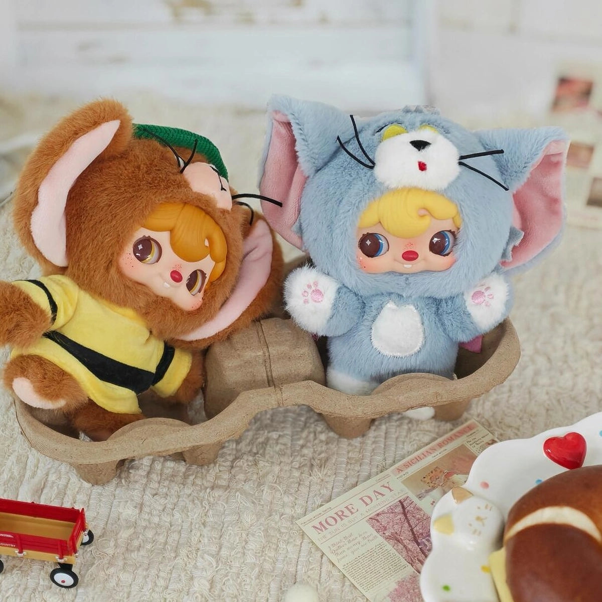 Secret Jerry and gray Tom POUKAPOUKA costume plush toys riding in a cardboard tray