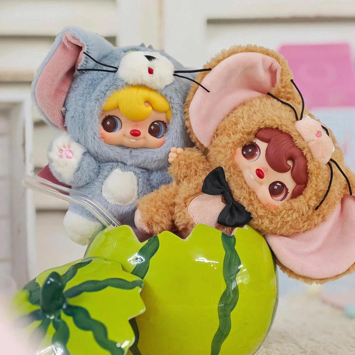 POUKAPOUKA gray Tom and brown Jerry costume plush toys leaning over a green melon prop