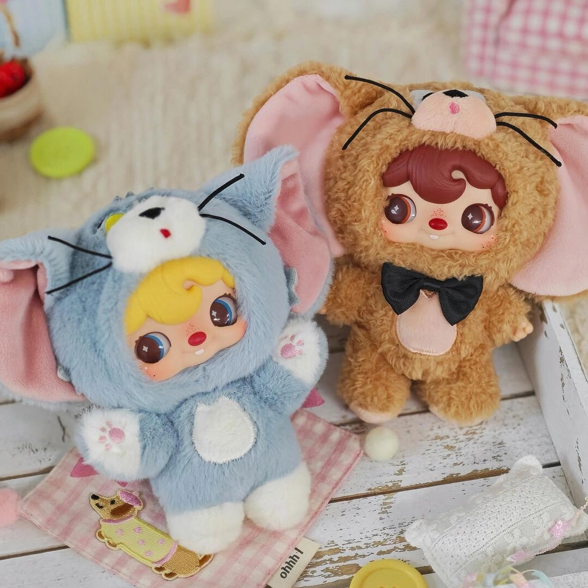 POUKAPOUKA gray Tom and brown Jerry costume plush toys posed together on a craft table