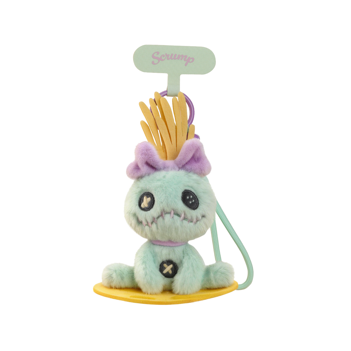 Scrump plush phone strap seated on a yellow surfboard