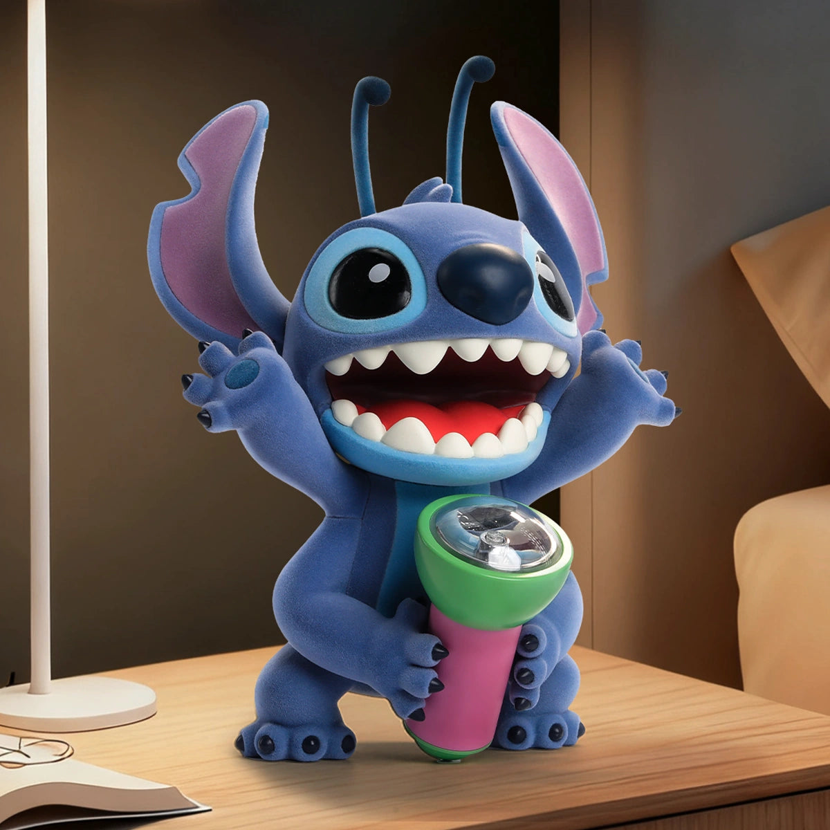 Stitch Flashlight Fright figure raising both arms while holding the flashlight on a desk