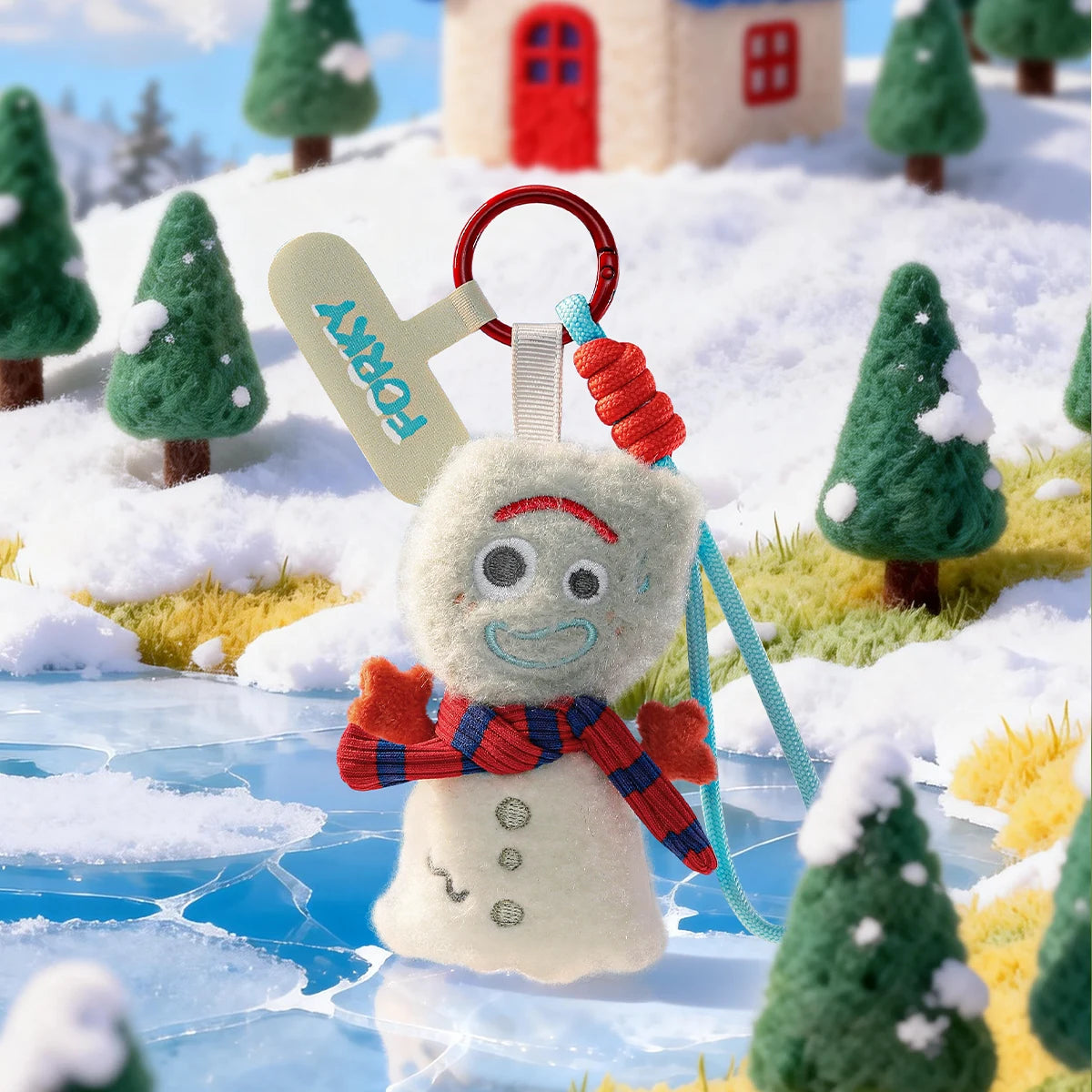 Forky plush phone charm dressed as a snowman beside a frozen pond