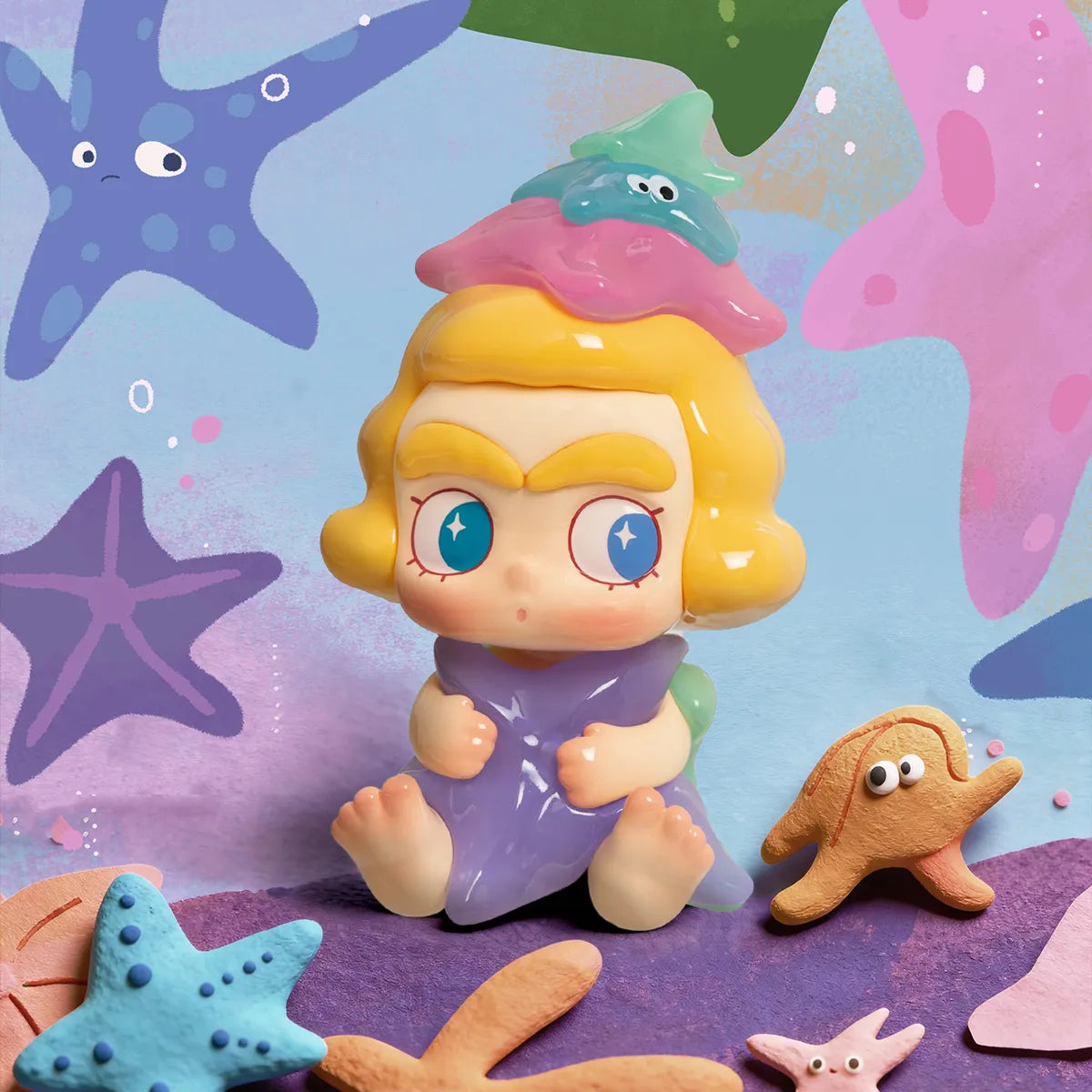 Starfish's Murmur figure in purple dress with pastel starfish hat surrounded by starfish, CiCiLu The Tide Shop