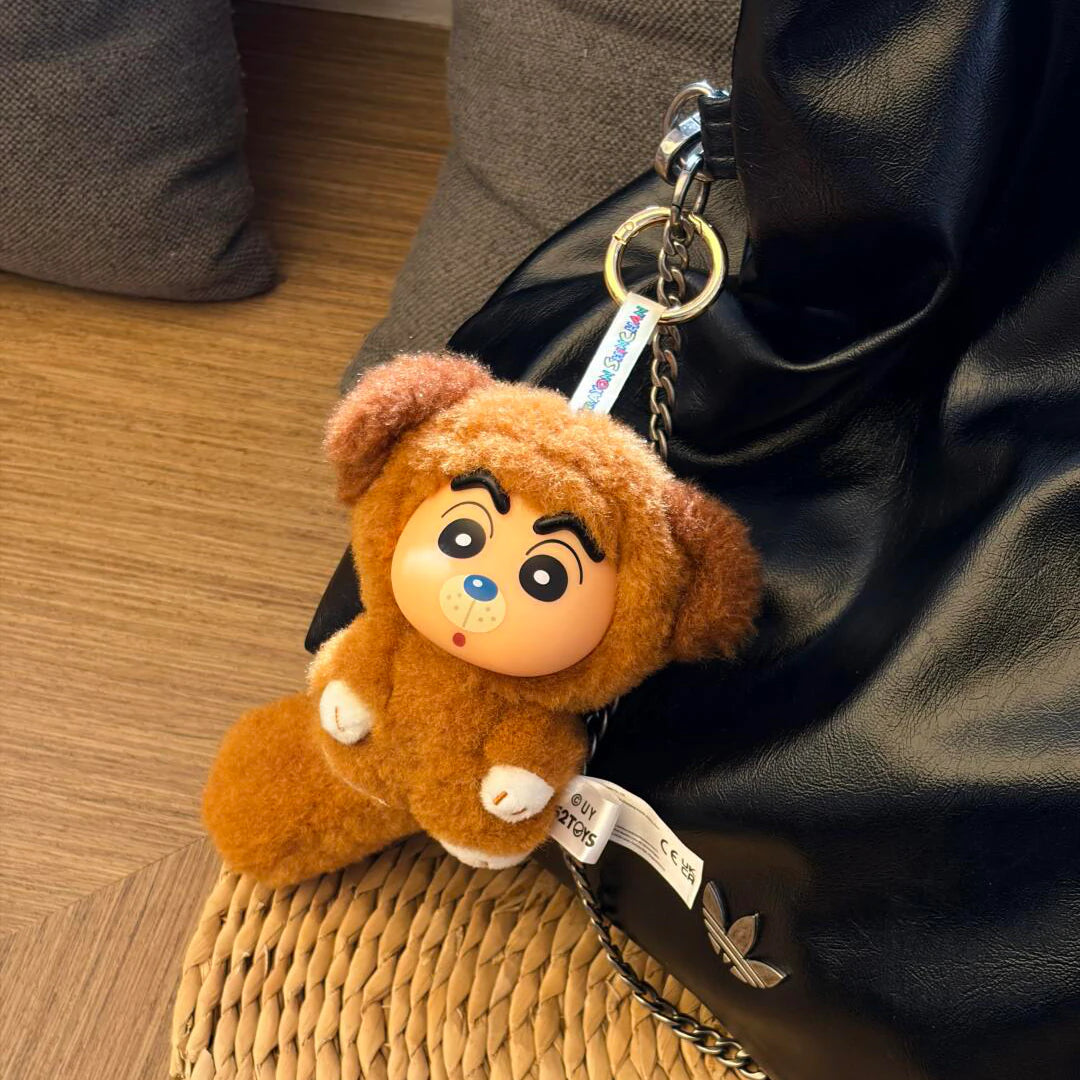 Shinchan Big Tails brown dog-costume plush keychain attached to a black bag