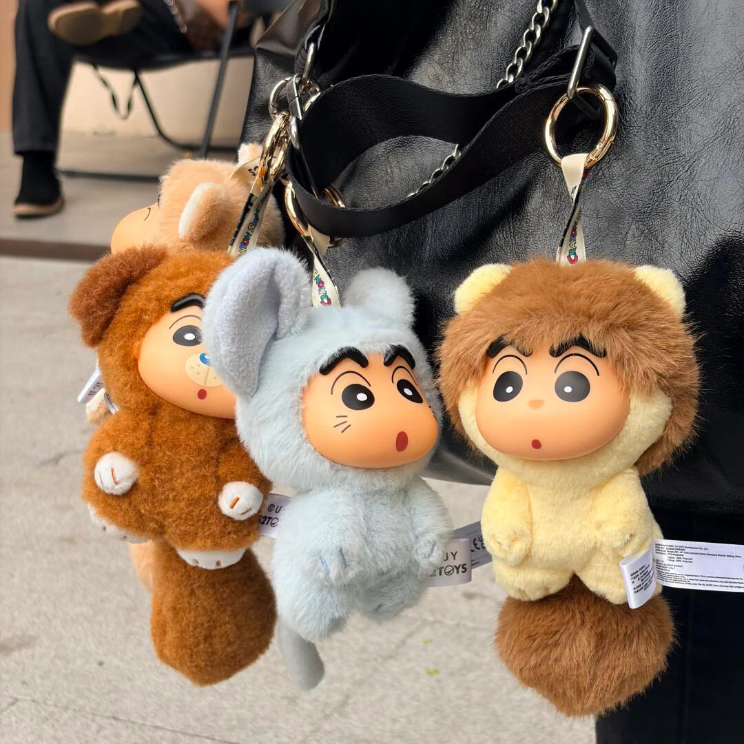 Three Shinchan Big Tails animal-costume plush keychains hanging from a black bag