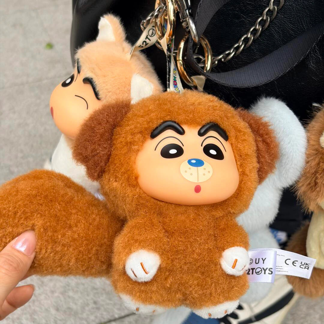Hand holding a Shinchan Big Tails brown dog-costume plush with long fluffy tail