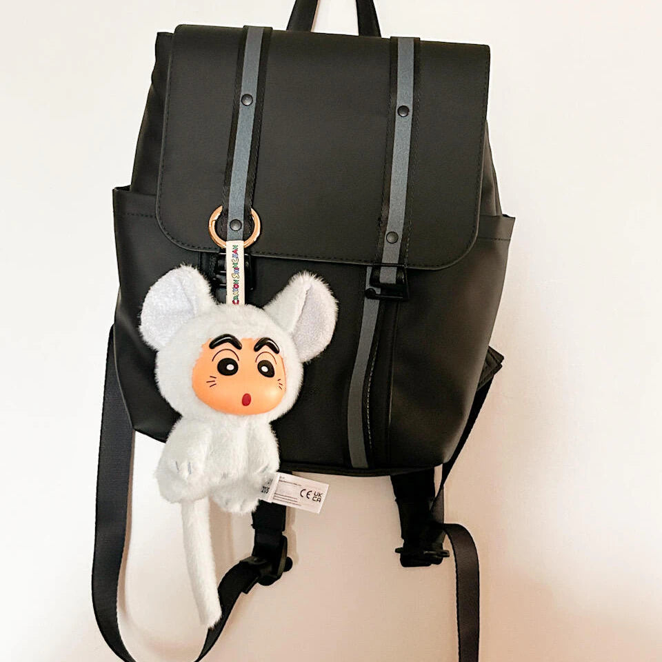 Gray mouse-costume Shinchan Big Tails plush keychain attached to a black backpack