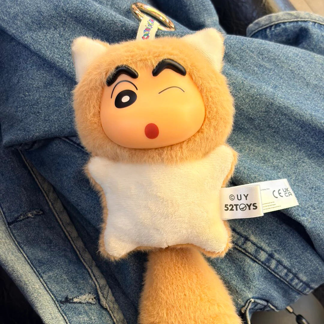 Shinchan Big Tails cat-costume plush keychain resting on blue jeans