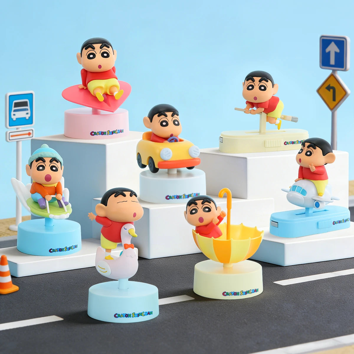 All seven Crayon Shinchan Let's Go Together! figures displayed on a street scene with road signs, blind box