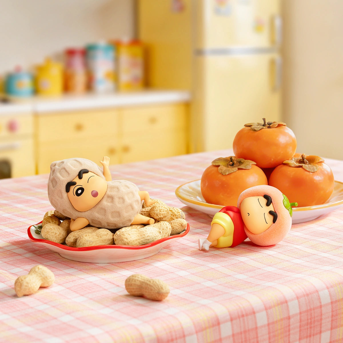 Peanut's Turn and Just Persimmon Shinchan figures lounging on a kitchen table, Crayon Shinchan Munch On Fruit