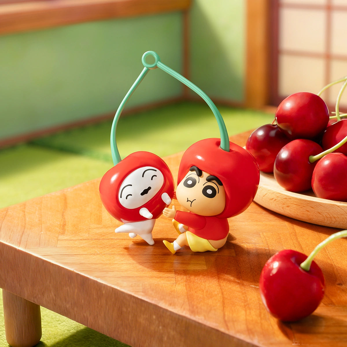 Cherry on Top Shinchan and Shiro cherry charms beside fresh cherries on a table, Crayon Shinchan Munch On Fruit