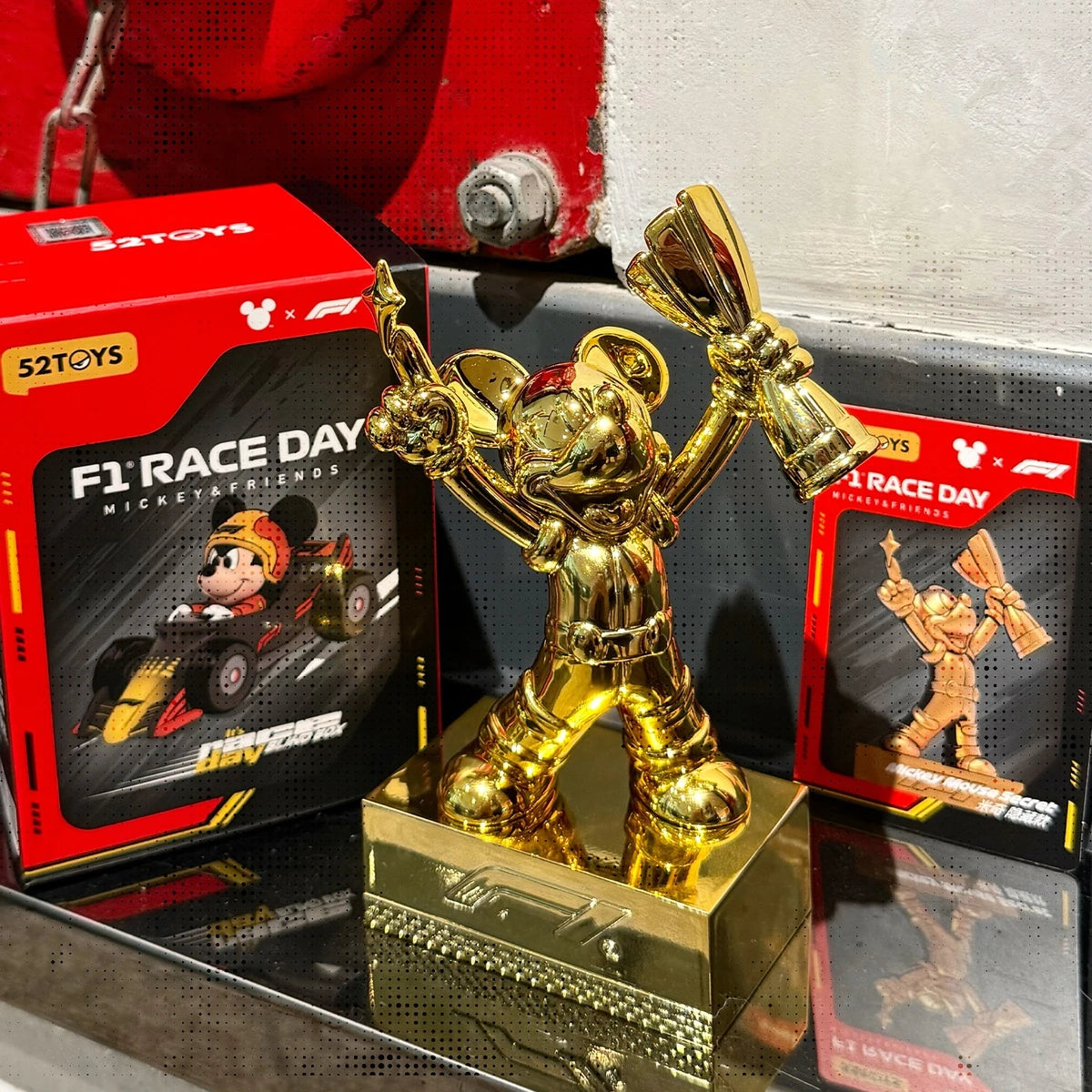 Secret gold Mickey Mouse F1 trophy displayed beside Race Day blind boxes