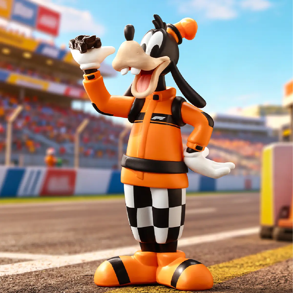 Goofy in orange pit-crew overalls holding a black racing part