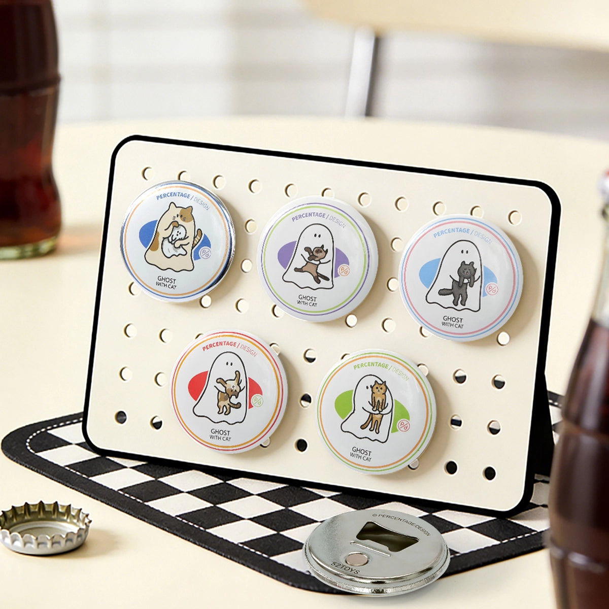 Five Ghody ghost-with-cat bottle openers displayed on a stand with soda bottles, blind box