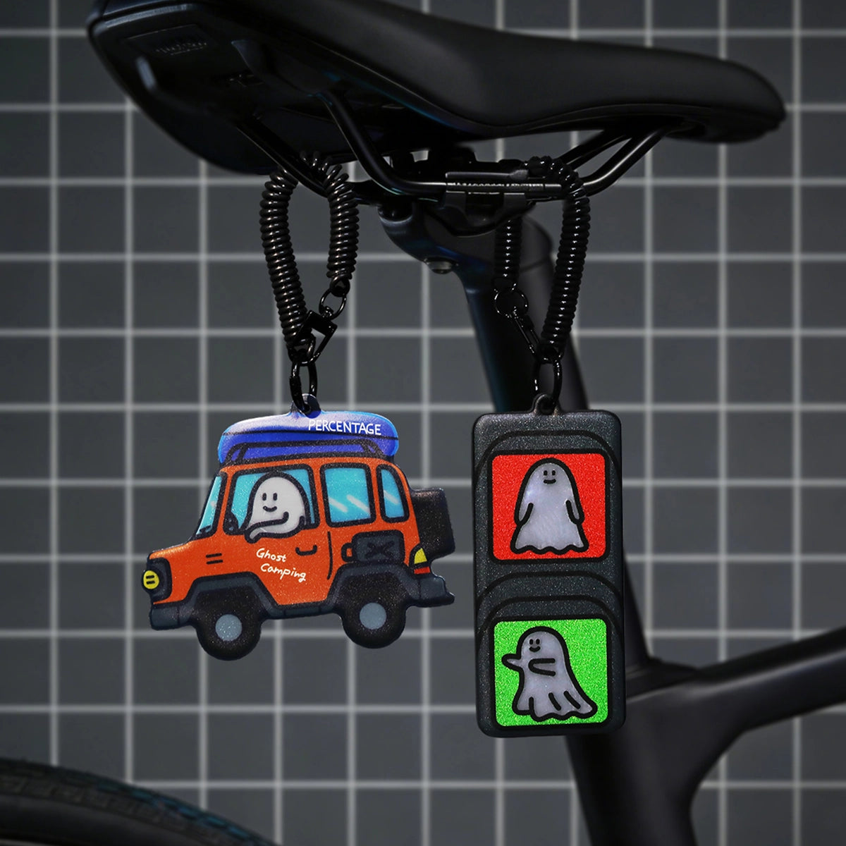 Ghody-Reflective Charm-Camping Trip jeep charm clipped to a bike saddle beside the traffic light charm