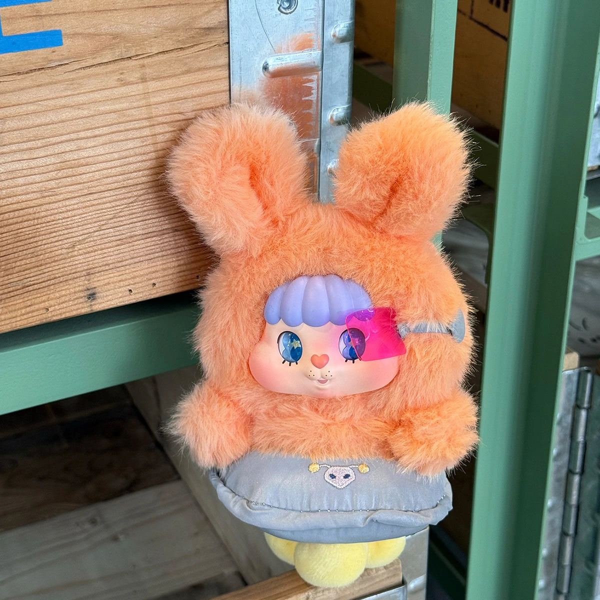 Little Buns orange rabbit plush character seated in a silver flying-saucer costume