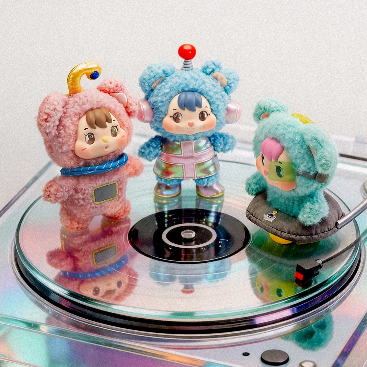 Three Little Buns space fantasy plush characters displayed on a mirrored turntable