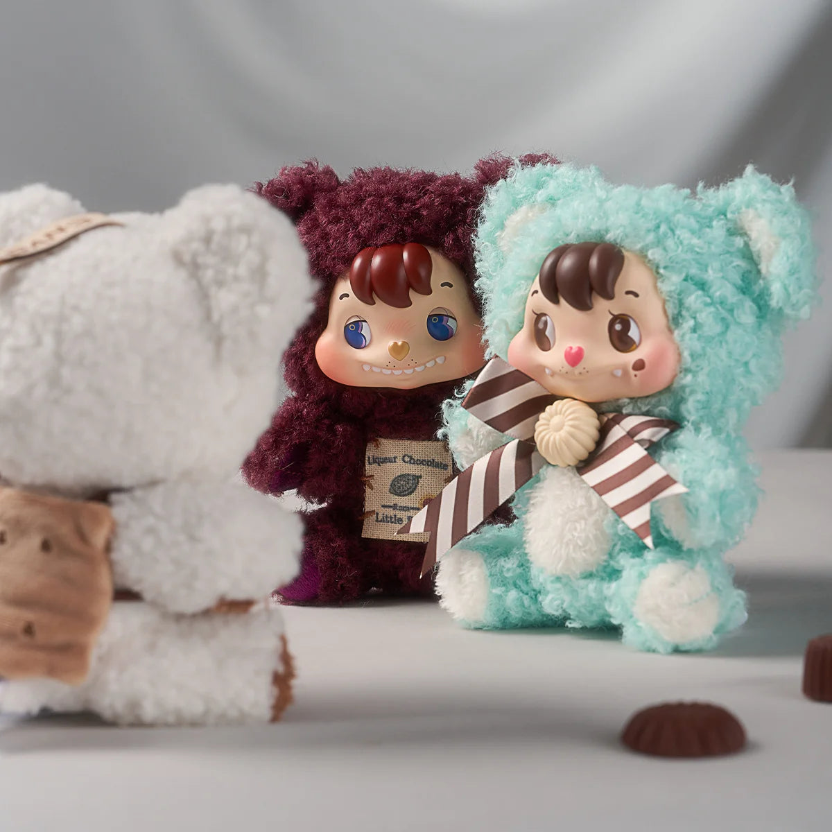 Liqueur maroon and Mint green Little Buns figures with label tags and striped scarf, Melting Together