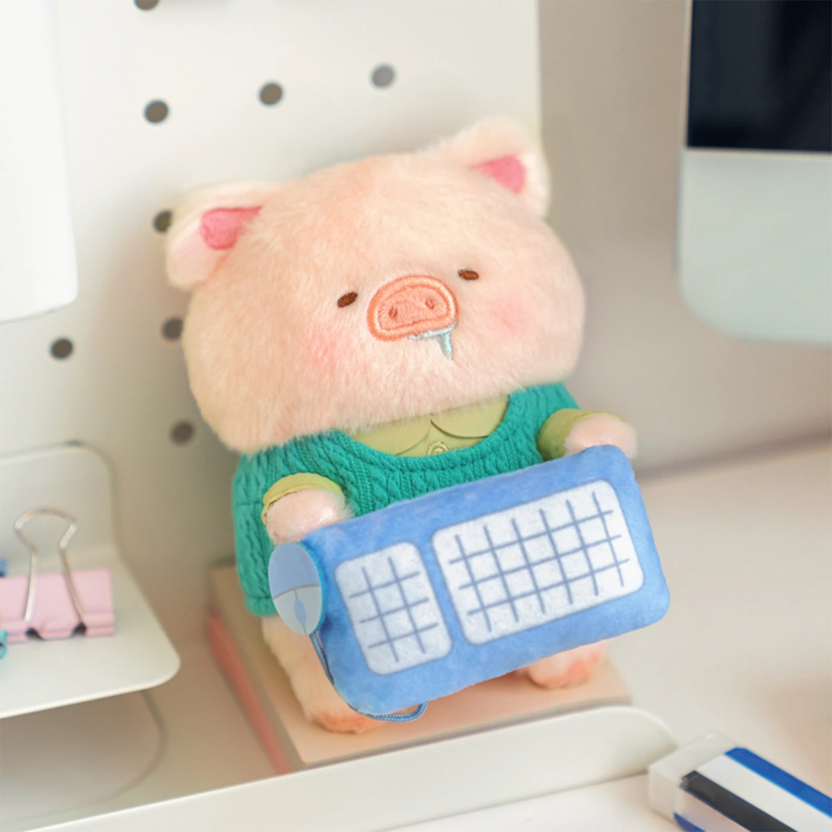 Super Tired Lu piggy plush keychain in green sweater hugging a blue keyboard, LuLu Piggy Office