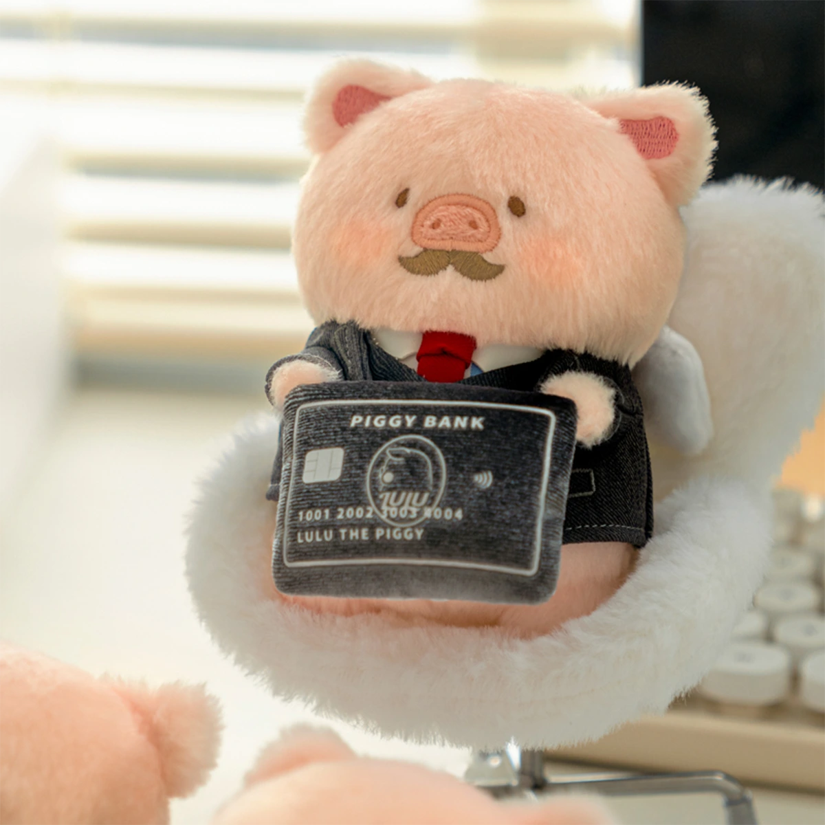 I Quit Lu CEO piggy plush keychain with mustache holding a PIGGY BANK card, LuLu Piggy Office