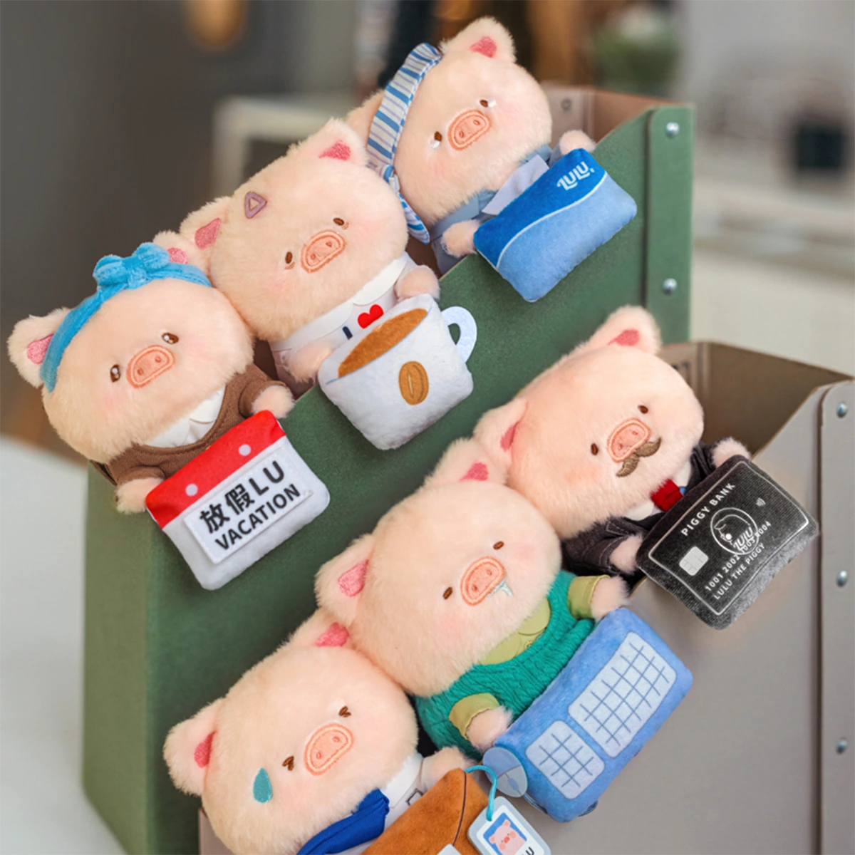 LuLu Piggy Office plush keychains clipped on a monitor edge, workplace partners blind box