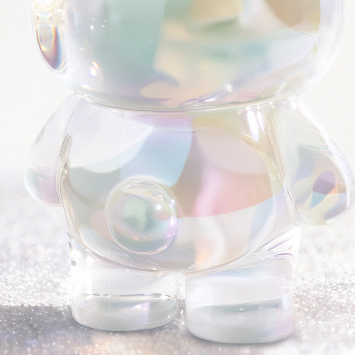 Close-up of a clear iridescent Lulu piggy figure body with bubble detail, Teddy Mini Ore Collection