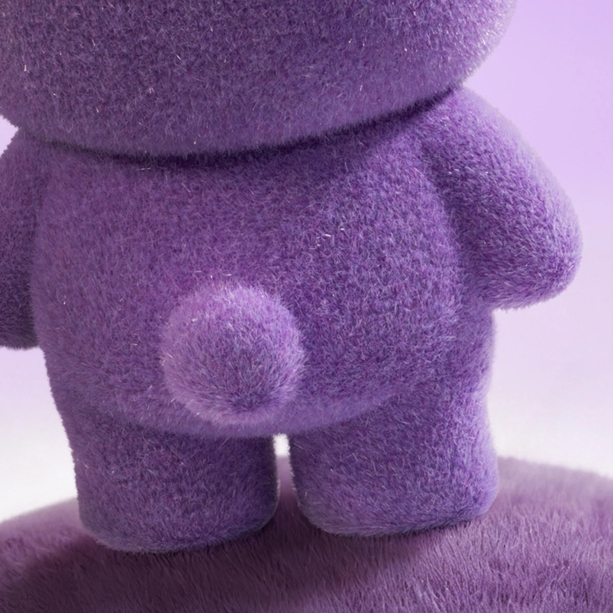 Close-up of a purple flocked Lulu piggy figure back showing fuzzy tail, Teddy Mini Ore Collection