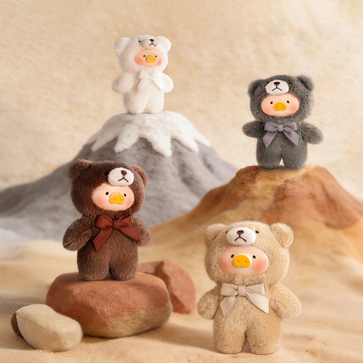 Snow white, Rock grey, Fruit brown and Dune tan Lulu teddy charms on a sandy mountain, Whispers of Nature