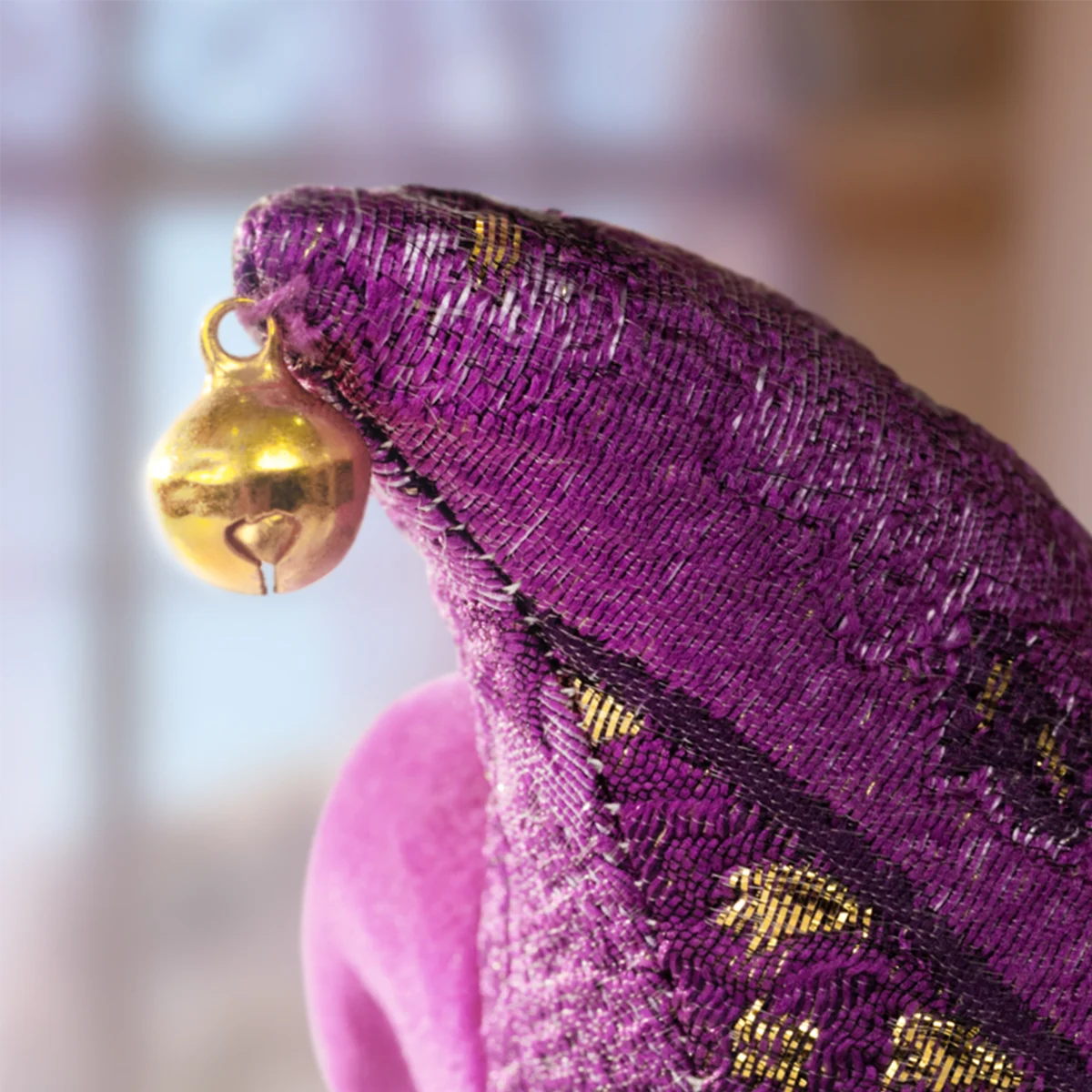 Close-up of purple jester hat with gold bell, Waiting Angel detail, Lulu The Piggy Triangel