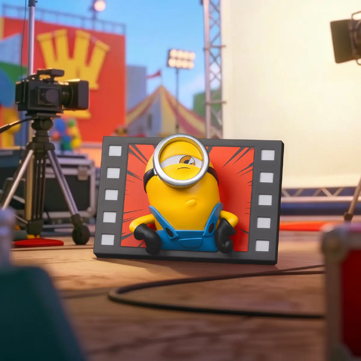 One-eyed Minion red filmstrip fridge magnet displayed on a miniature film set