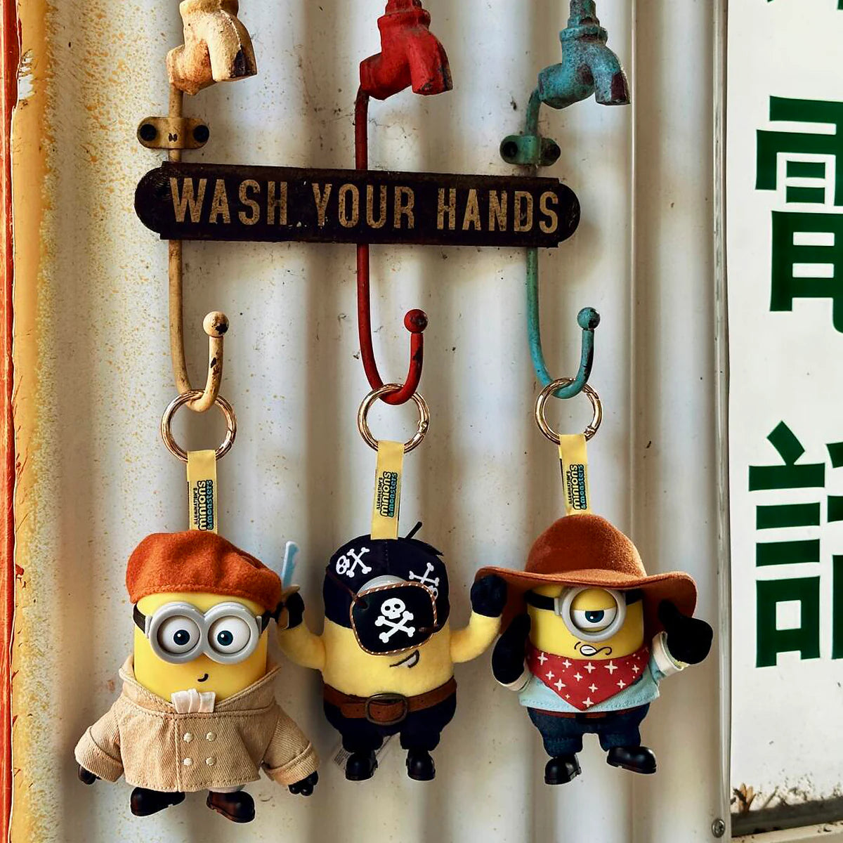Artist Henry, Pirate Carl, and Cowboy James plush keychains hanging from wall hooks