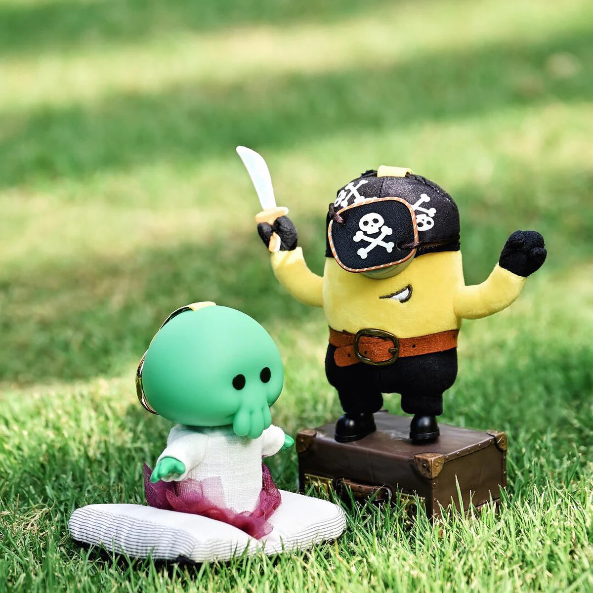 Pirate Carl and Goomi plush toys posed together on grass