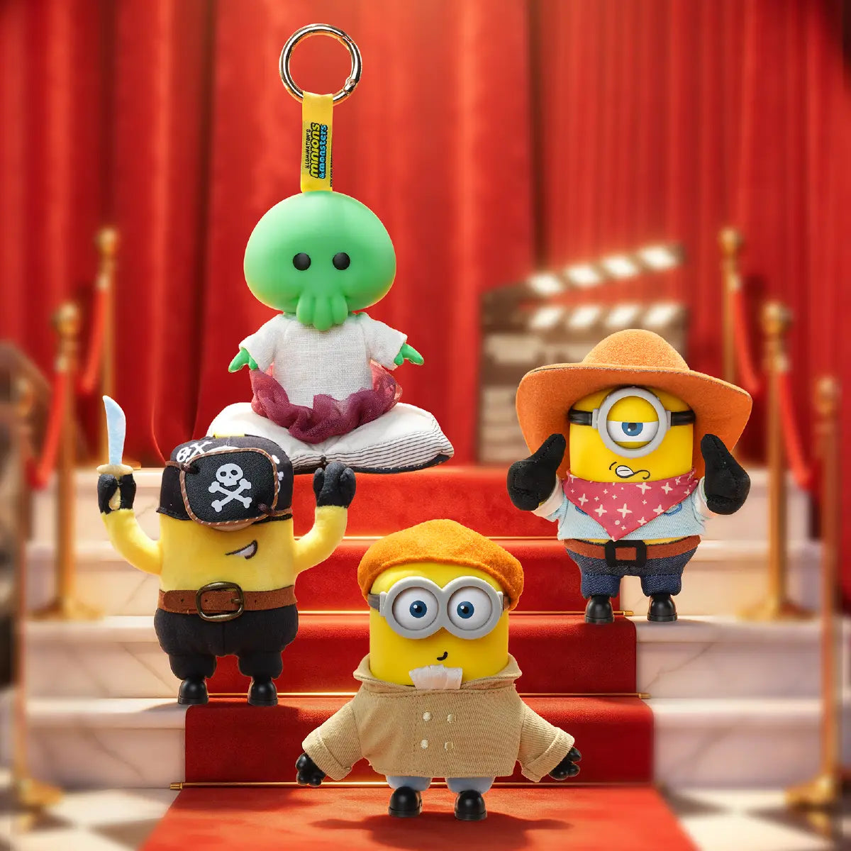 Goomi, Pirate Carl, Cowboy James, and Artist Henry plush keychains posed on a red-carpet staircase
