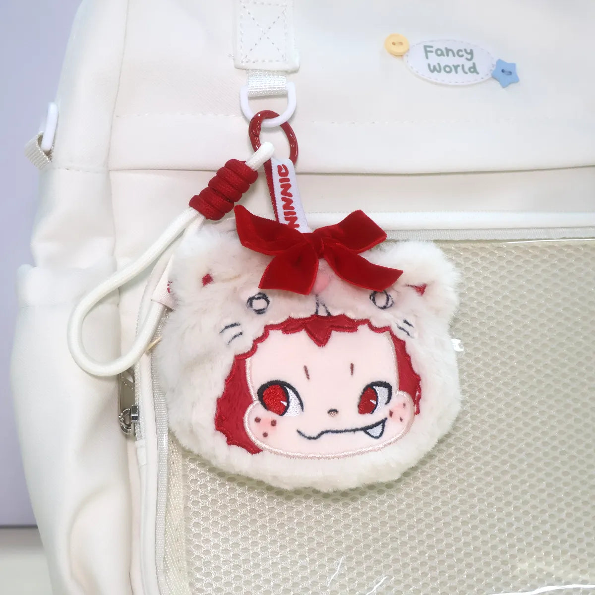 NINNIC Party Kitty plush charm hanging on a backpack mesh pocket, Wild & Free scented aroma charm