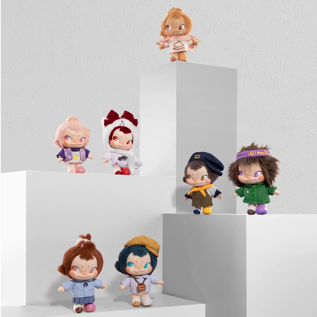 Full set of NINNIC Wild & Free plush keychain figures displayed on white pedestals, blind box